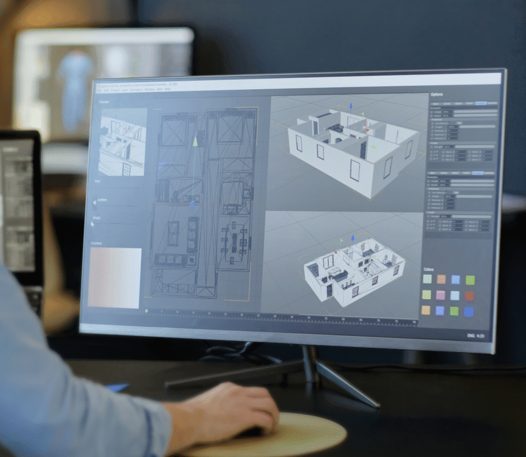 Asmuo dirba prie kompiuterio su 3D pastato dizaino ir brėžinių programine įranga monitoriuje